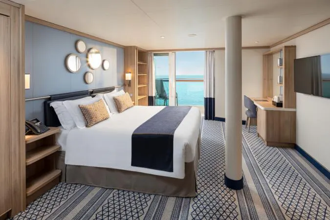 A spacious accessible cabin on P&O’s Iona, with a double bed, wide floor space and a balcony overlooking the sea.