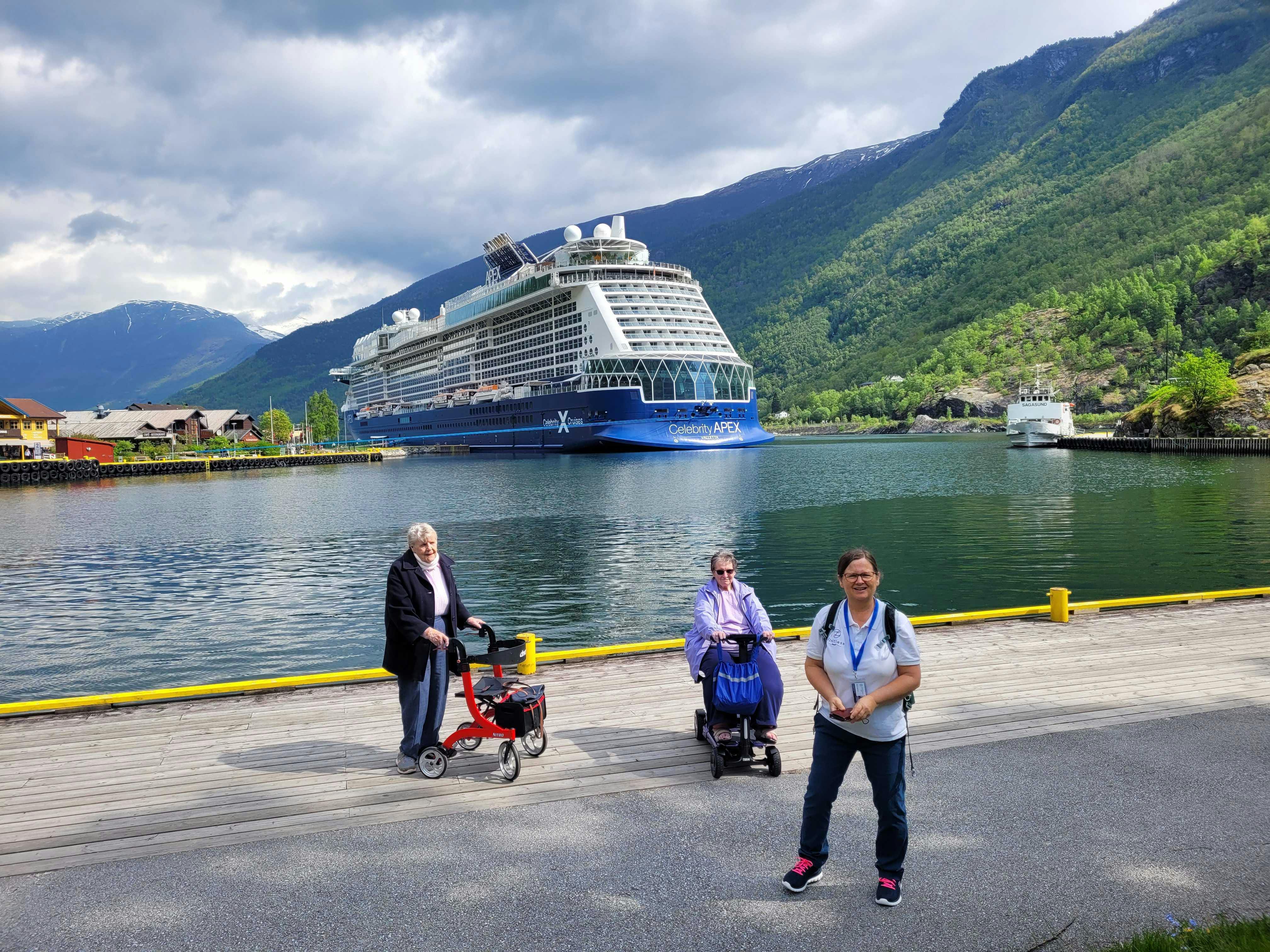 Cruise customers standing in front of the Celebrity Apex cruise ship in Norway