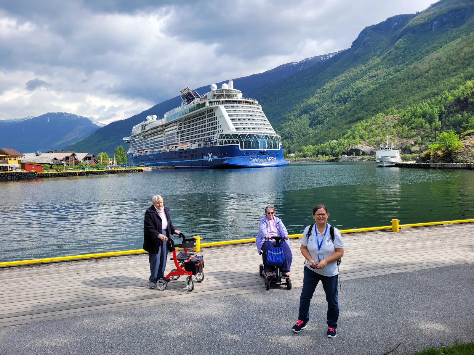 Cruise customers standing in front of the Celebrity Apex cruise ship in Norway