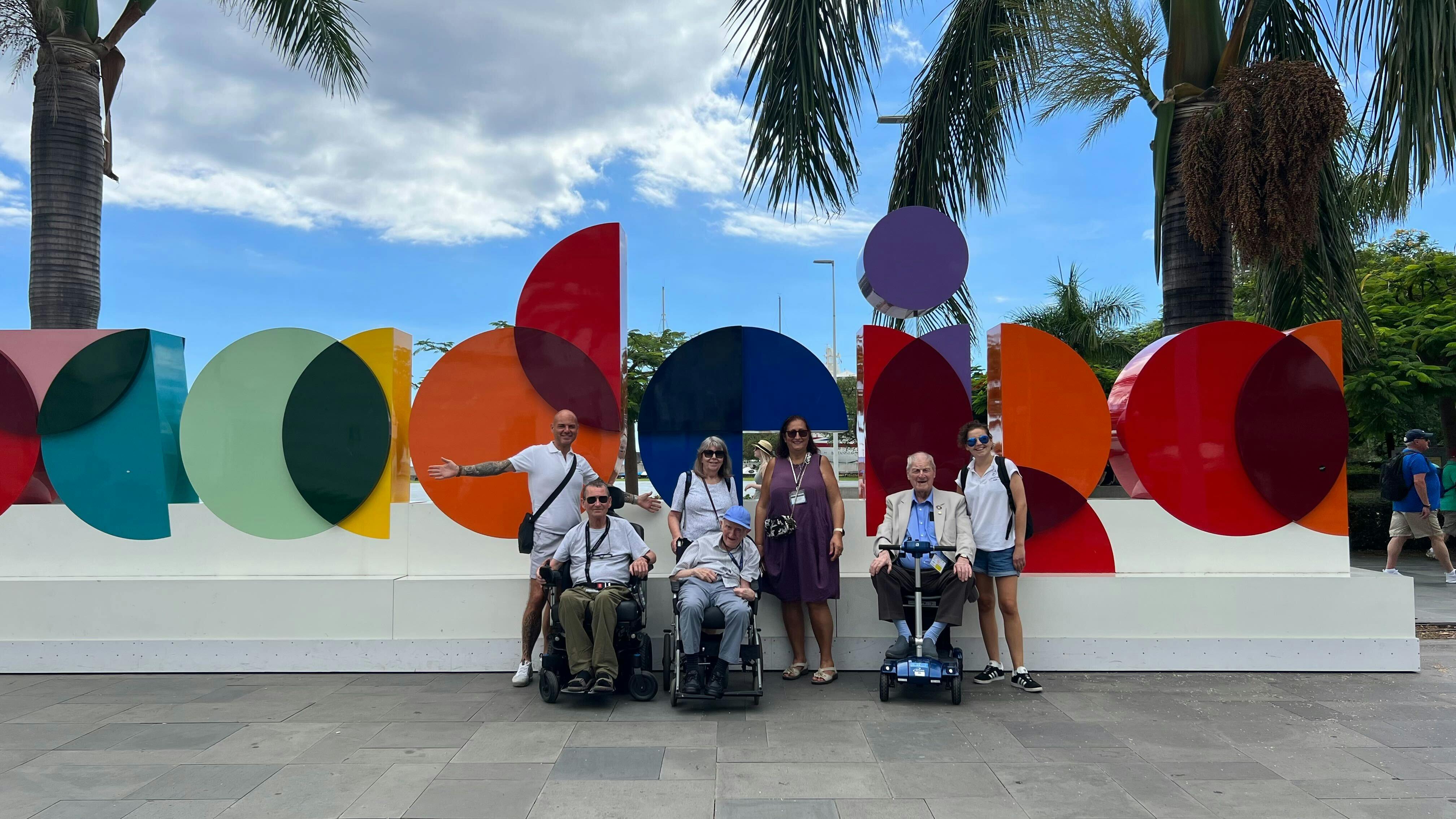Customers and staff in-front of the Madeira sign.