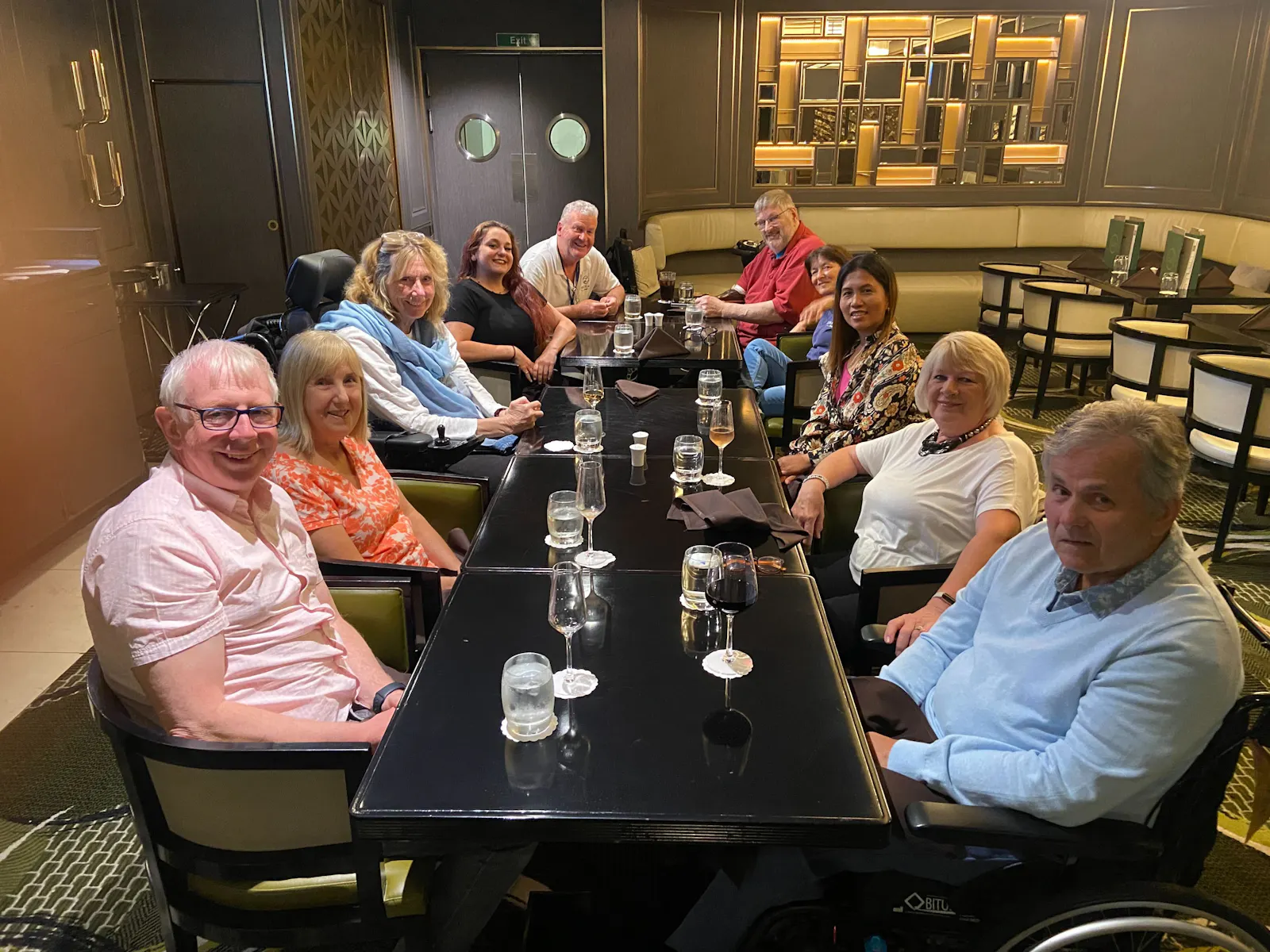 Cruise guests and staff enjoying a meal together on the Britannia