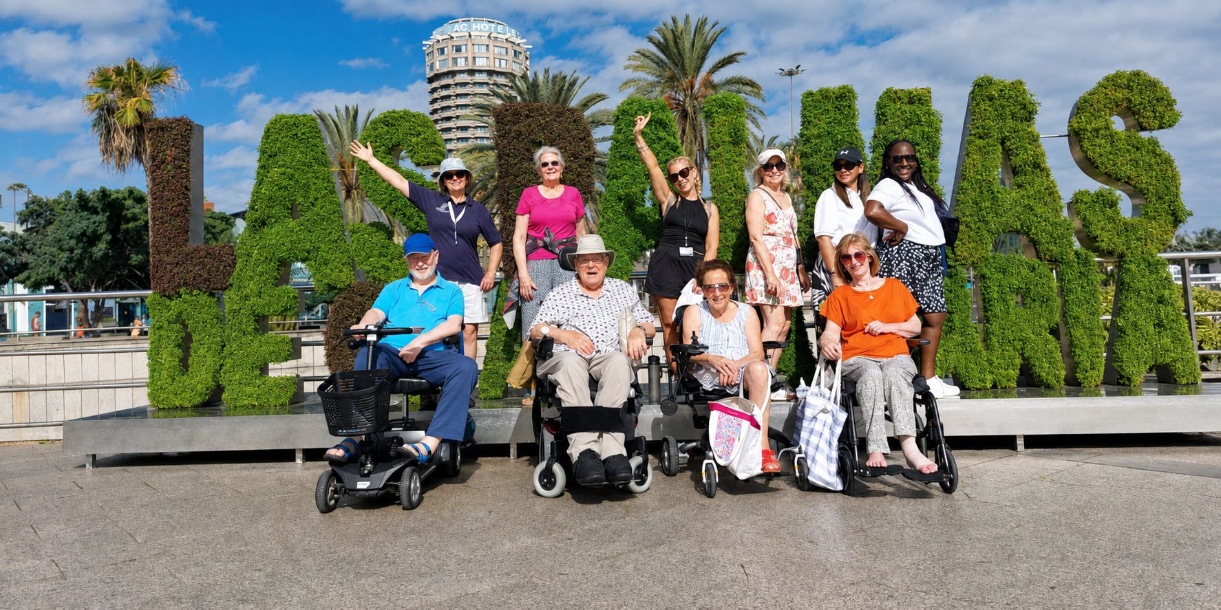 A group of Limitless Travellers gathered in front of the Las Palmas sign in Gran Canaria.