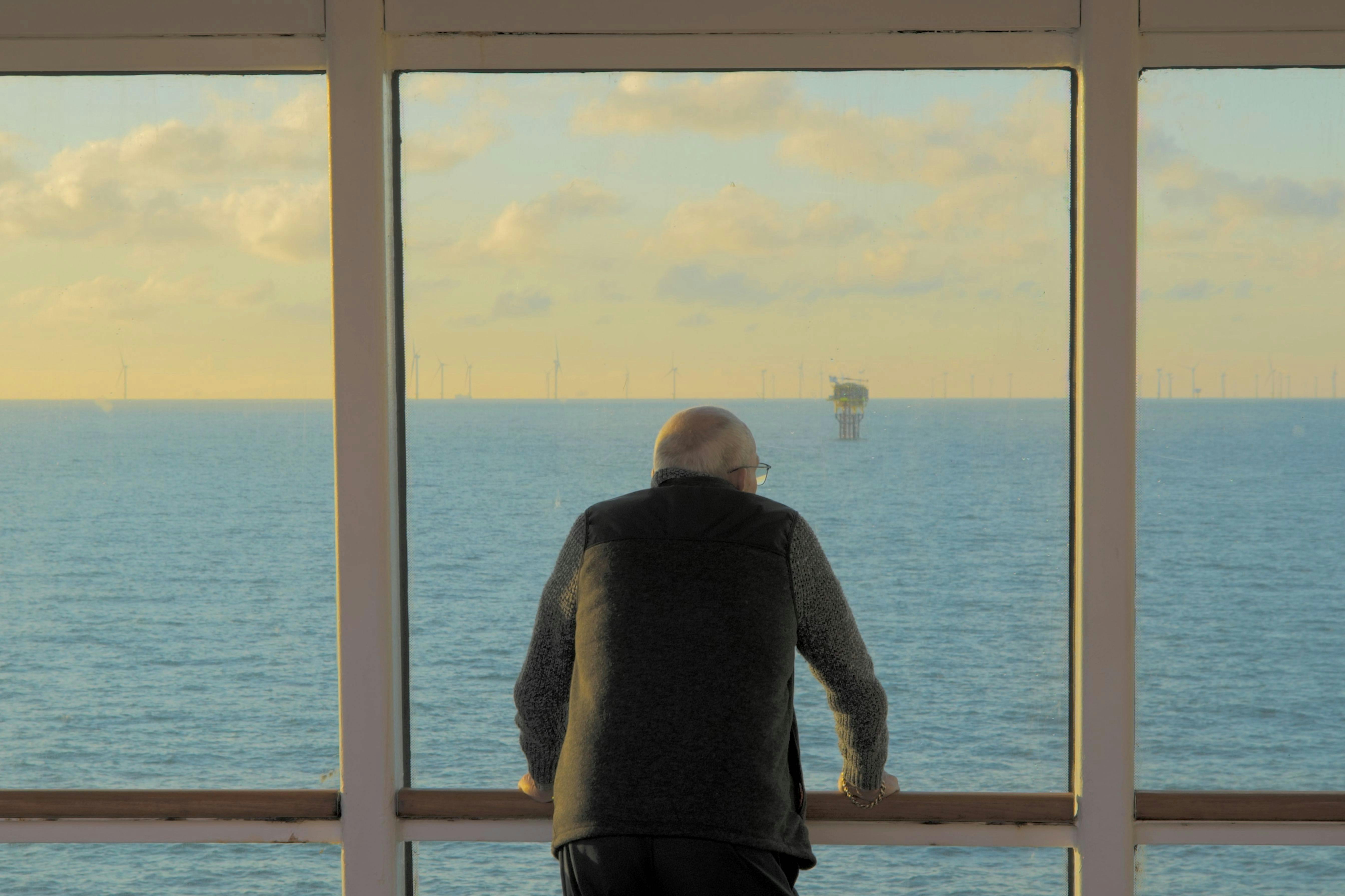 Customer looking out a window on a cruise