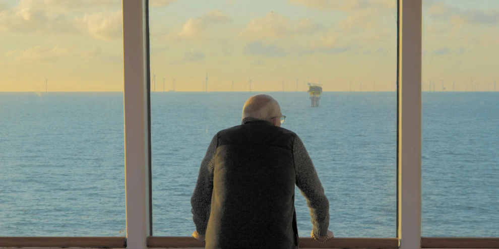 Customer looking out a window on a cruise