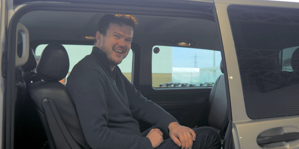 Cruise customer in transfer vehicle, before boarding cruise ship