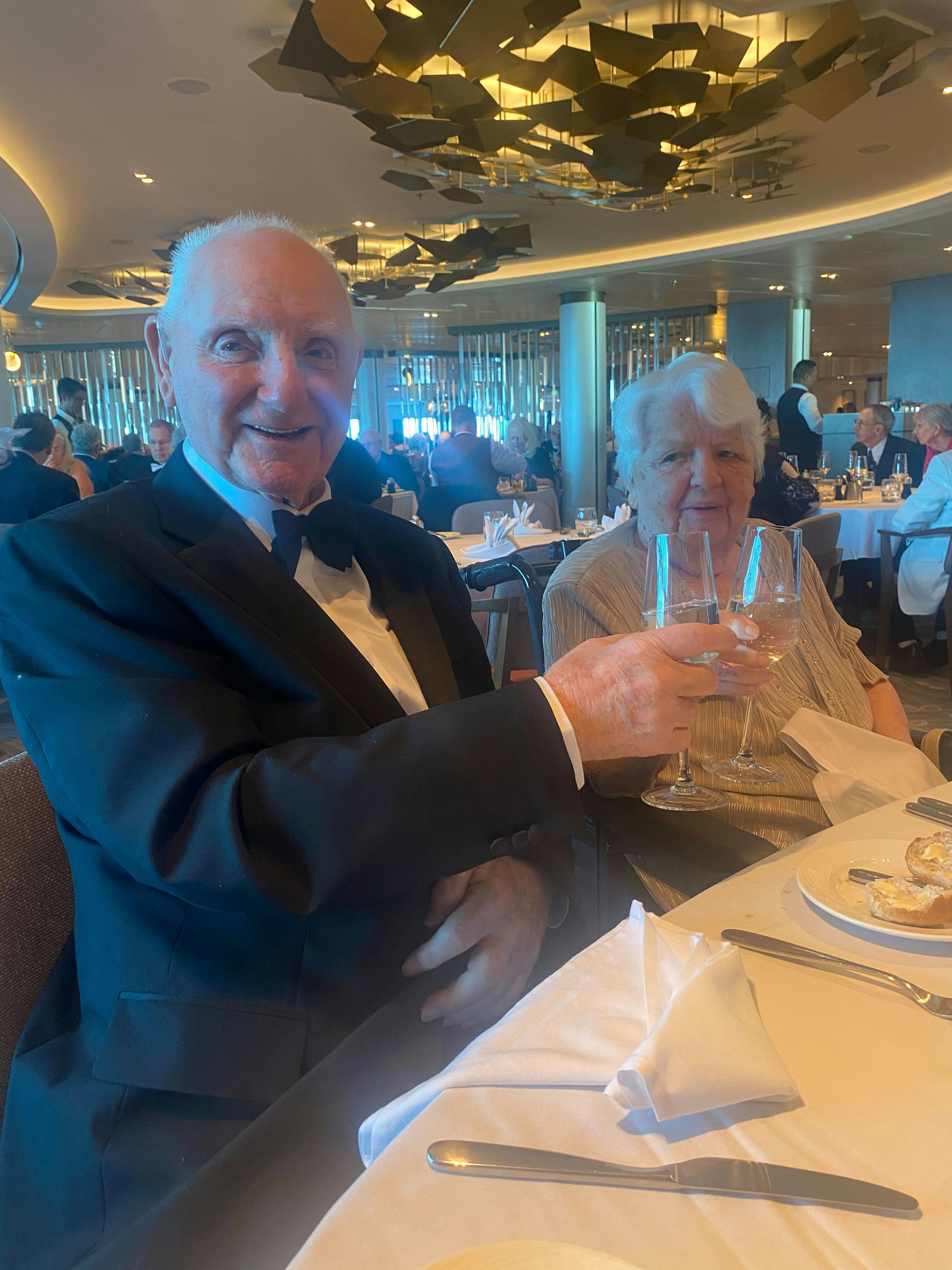 Cruise customers raising a glass at dinner