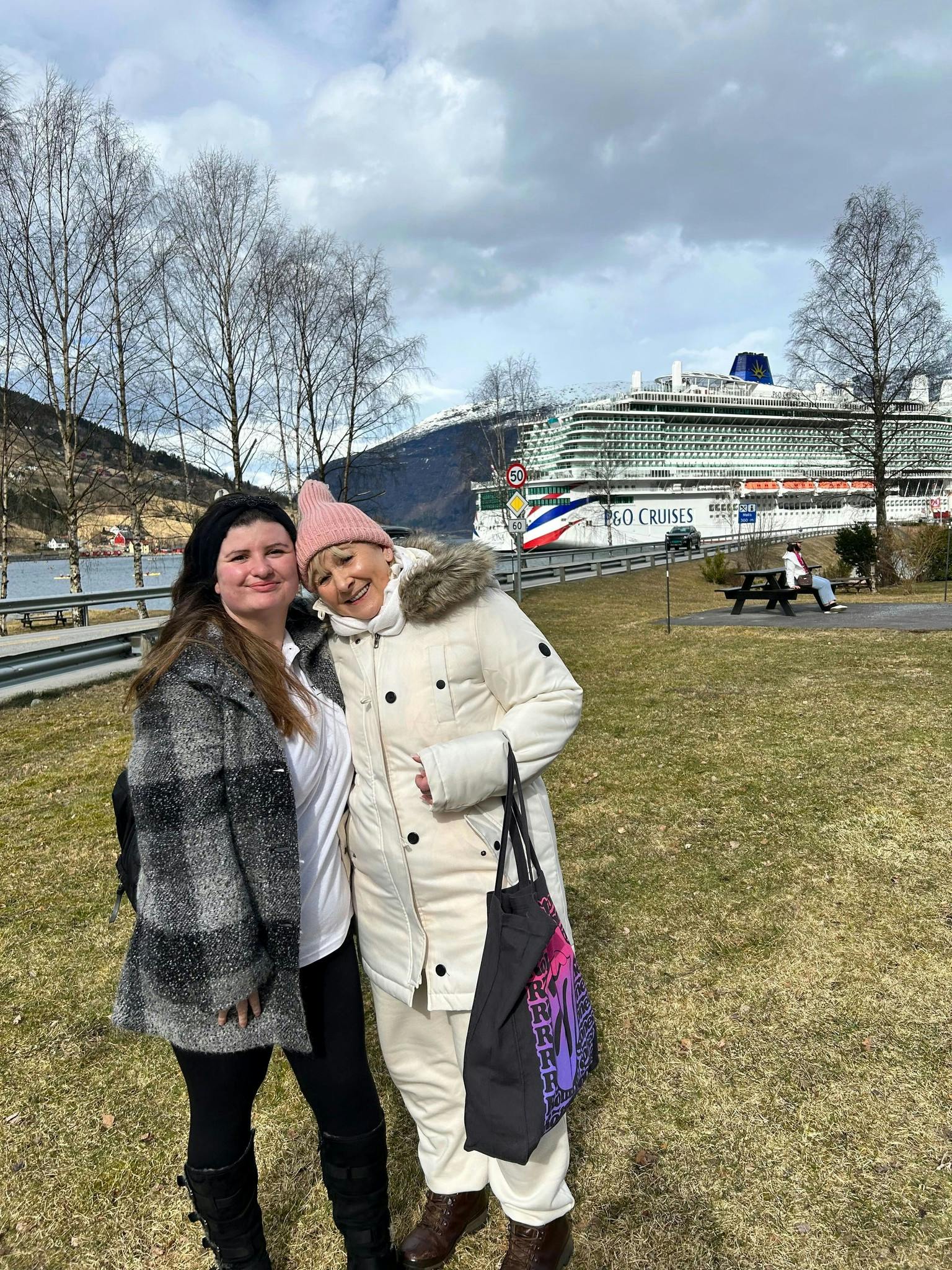 Customer and staff in front of a P&O cruise in Norway