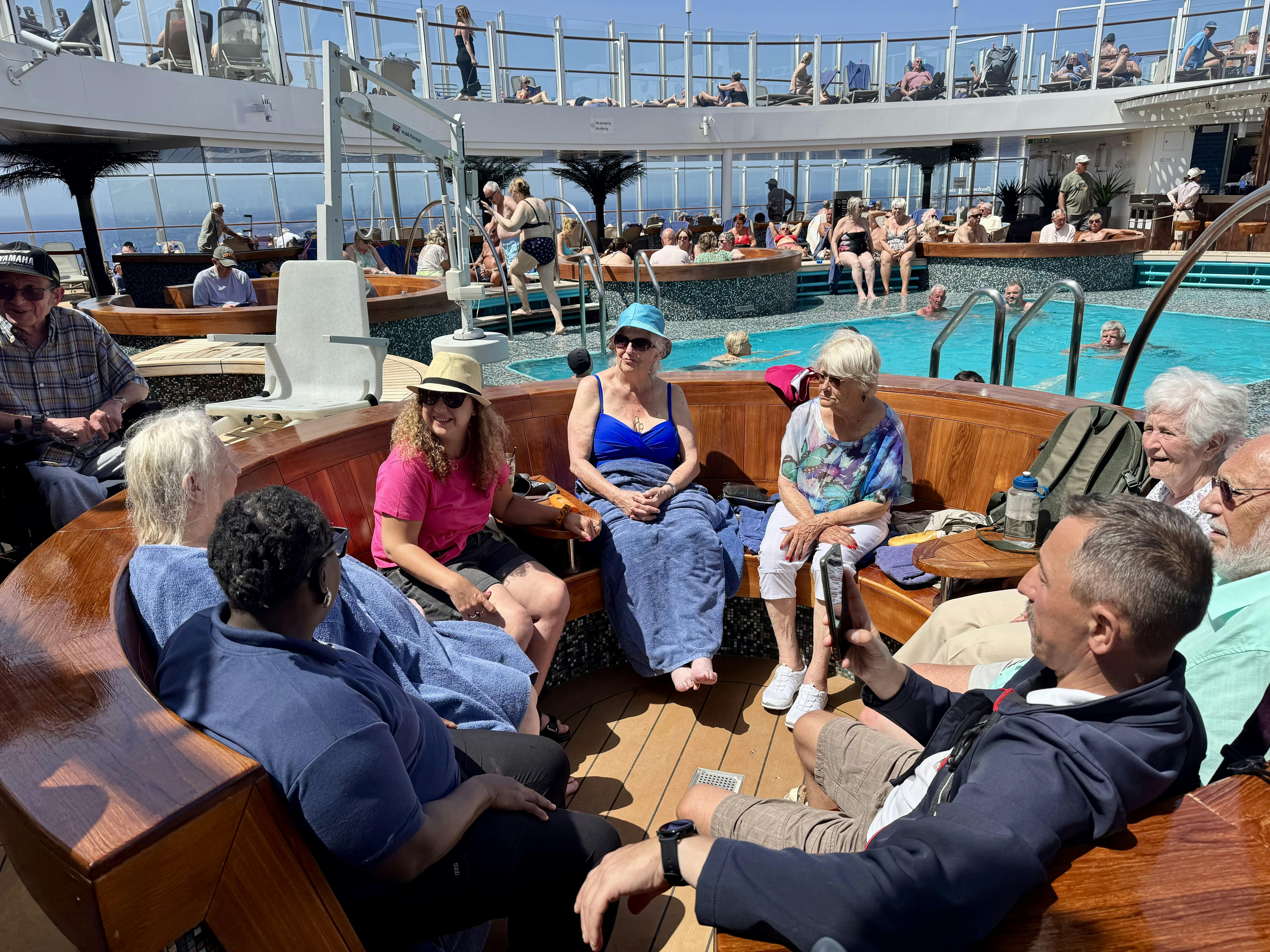 Customers and Limitless staff sat by the Pool on a P&O cruise ship