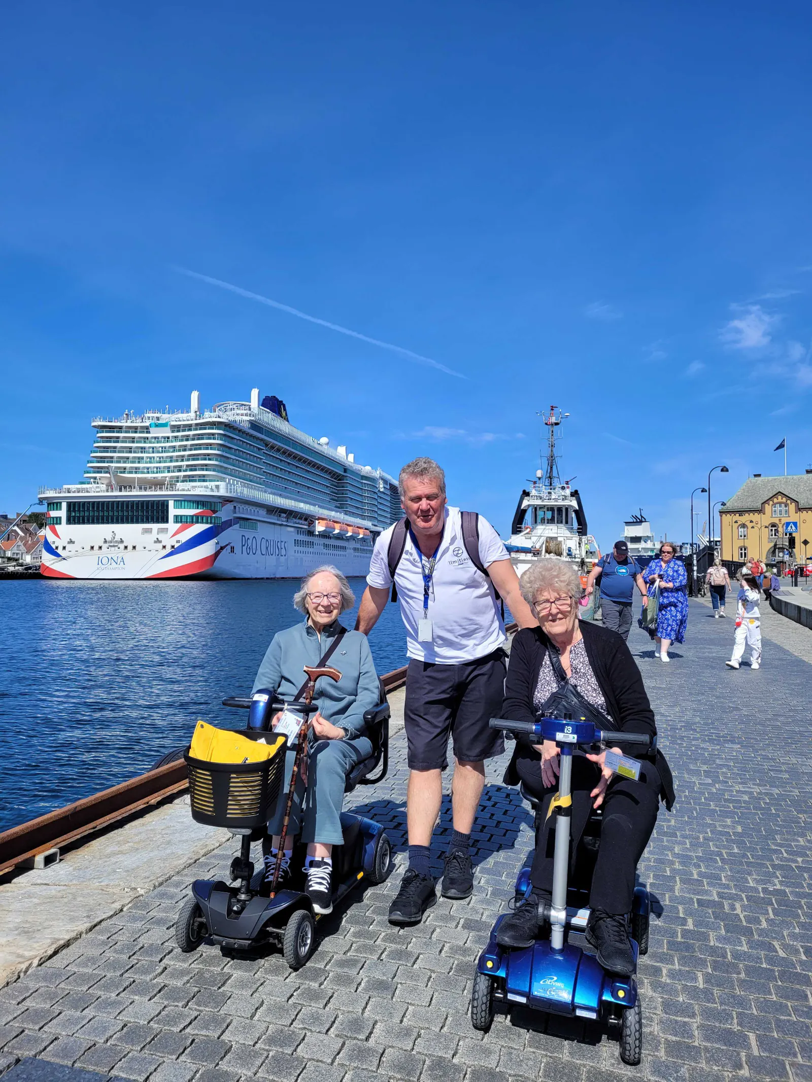 Elderly customers on a cruise holiday with Limitless staff, P&O Iona in the background