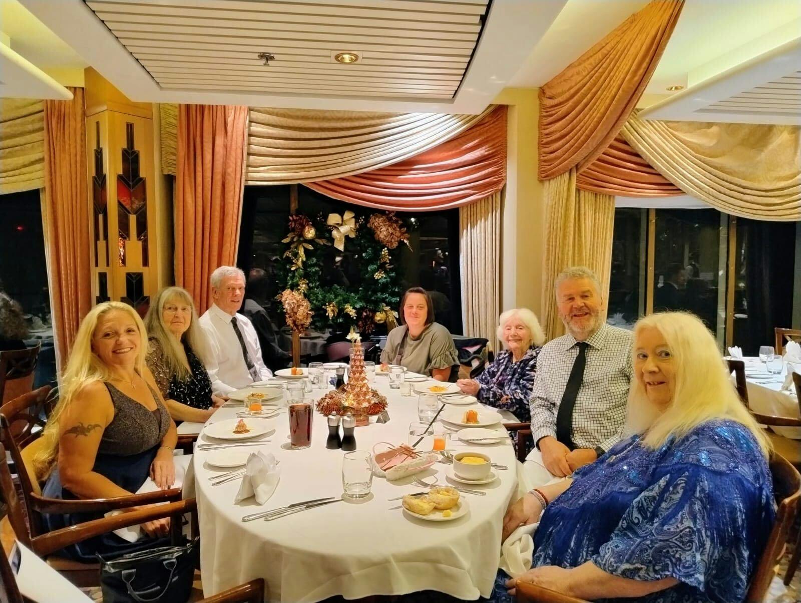 Customers and Limitless staff enjoying dinner at restaurant onboard cruise ship