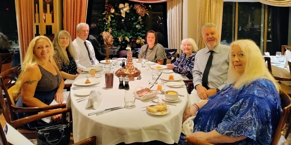 Customers and Limitless staff enjoying dinner at restaurant onboard cruise ship
