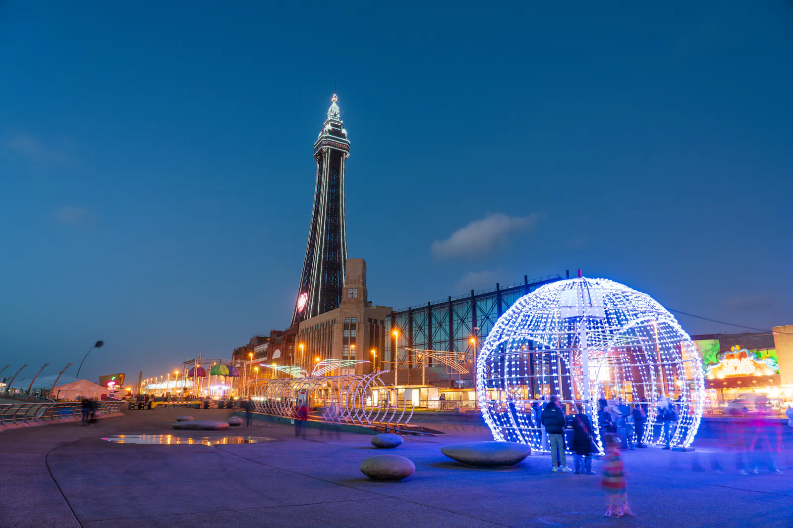 Blackpool seafront in the evening with the Blackpool Tower in the background.