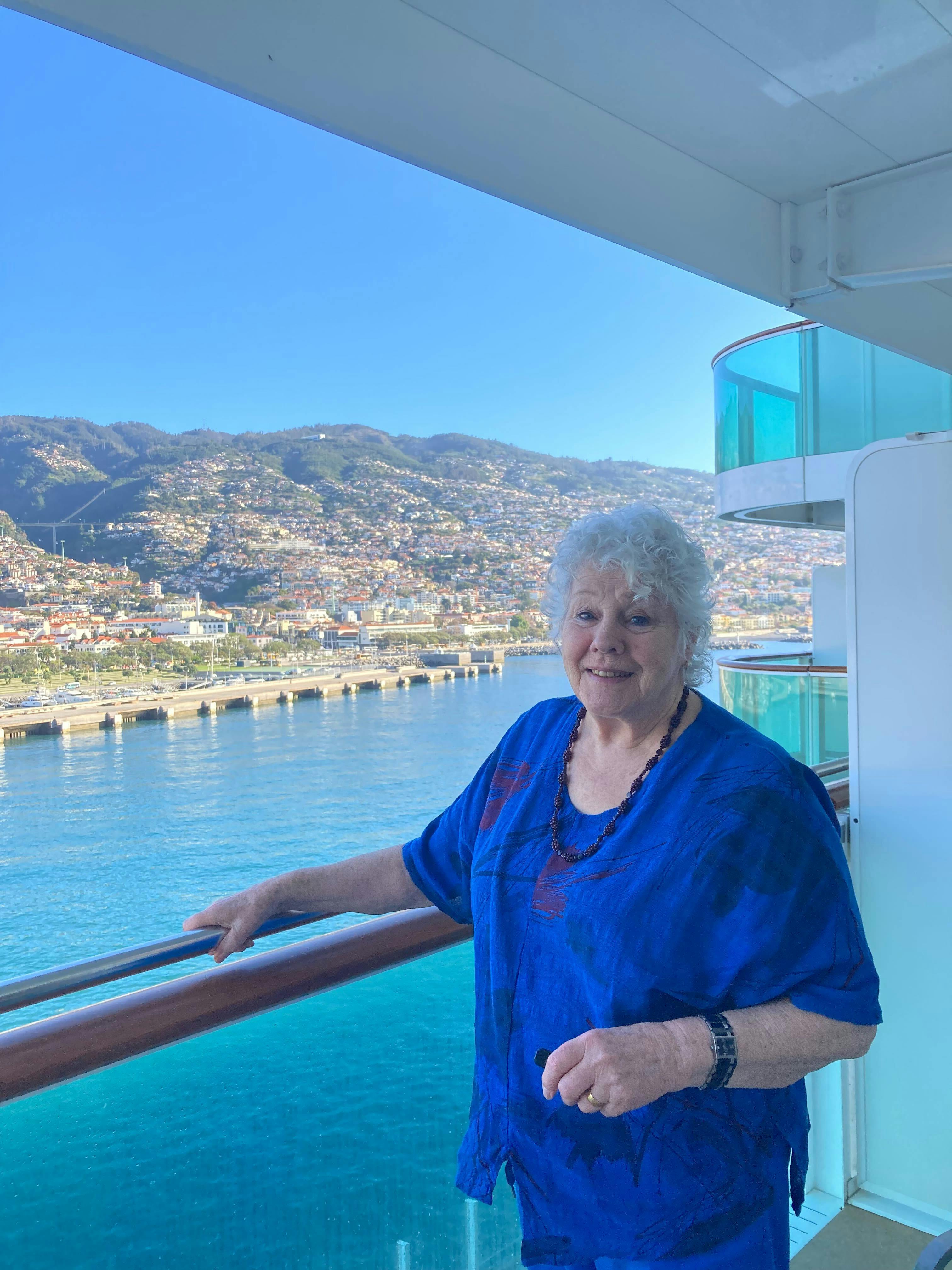 Customer enjoying views from balcony cabin on a Cruise ship